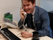 Student talkin on phone in a suit