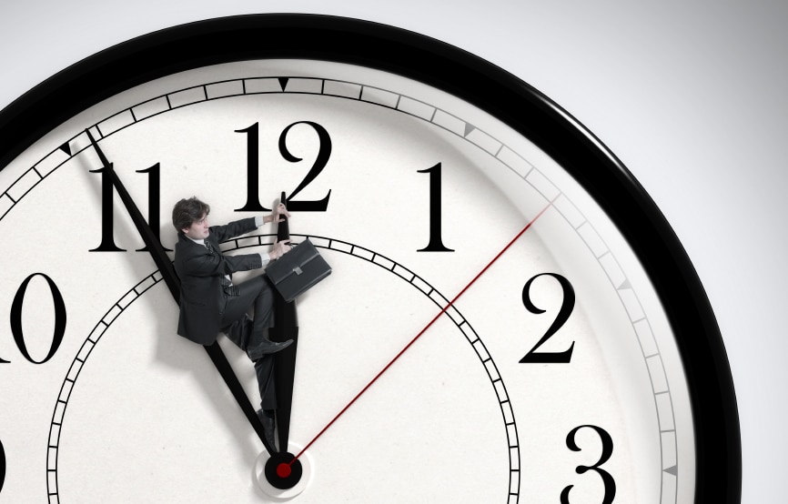 Ticking clock with man holding a briefcase riding the hour hand