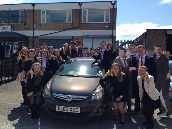 Enterprise Interns around a car